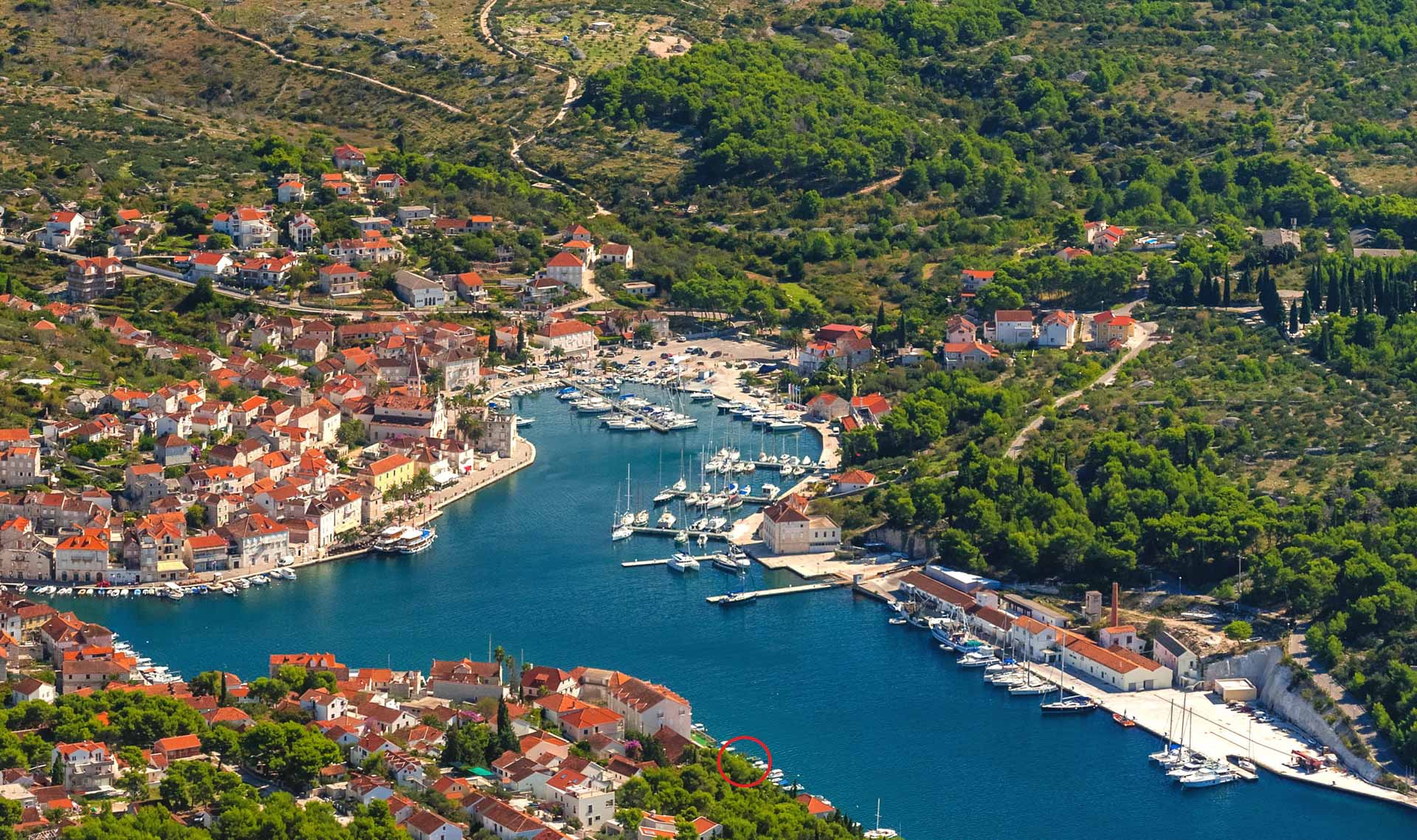 Aerial view of Milna's deep natural harbor and marina on Brač's western coast, with Villa Milna Bonavista's location marked