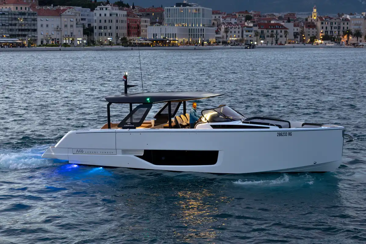Luxury tender boat departing Split's waterfront at dusk, used for private transfers to Brač