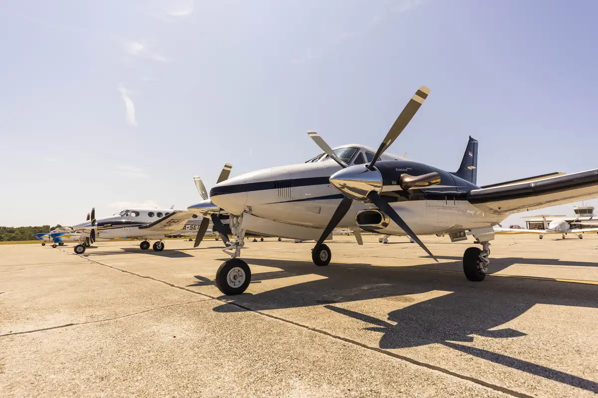 Private plane on the tarmac, used by a family flying to Mali Lošinj for their villa stay instead of the long road and ferry route