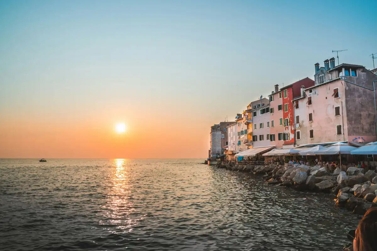 Sunset over the sea and old town waterfront of Rovinj, Istria