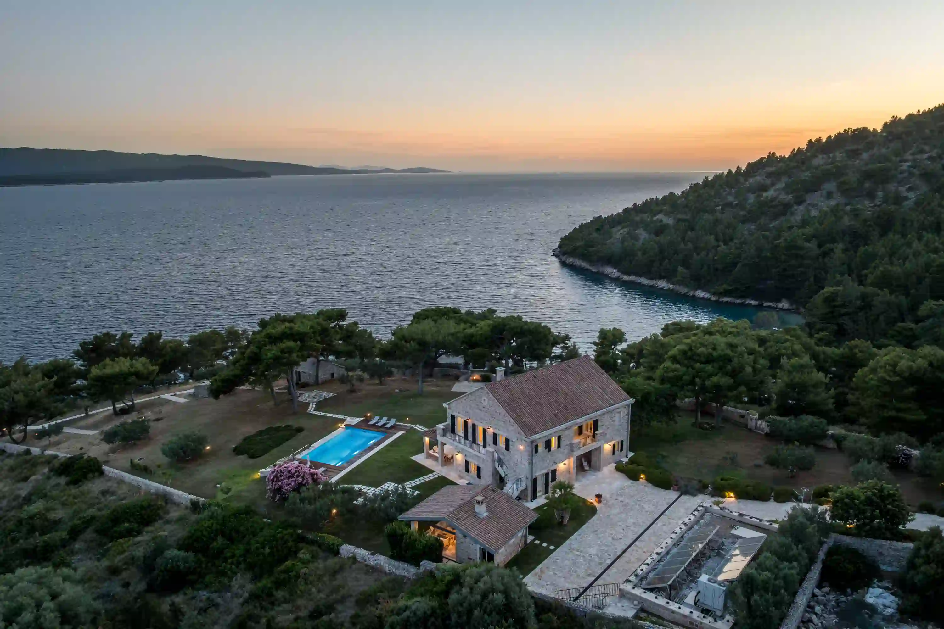 Aerial sunset view of Villa Beachfront Oasis, a secluded stone villa with pool in Murvica, near Bol, Brač