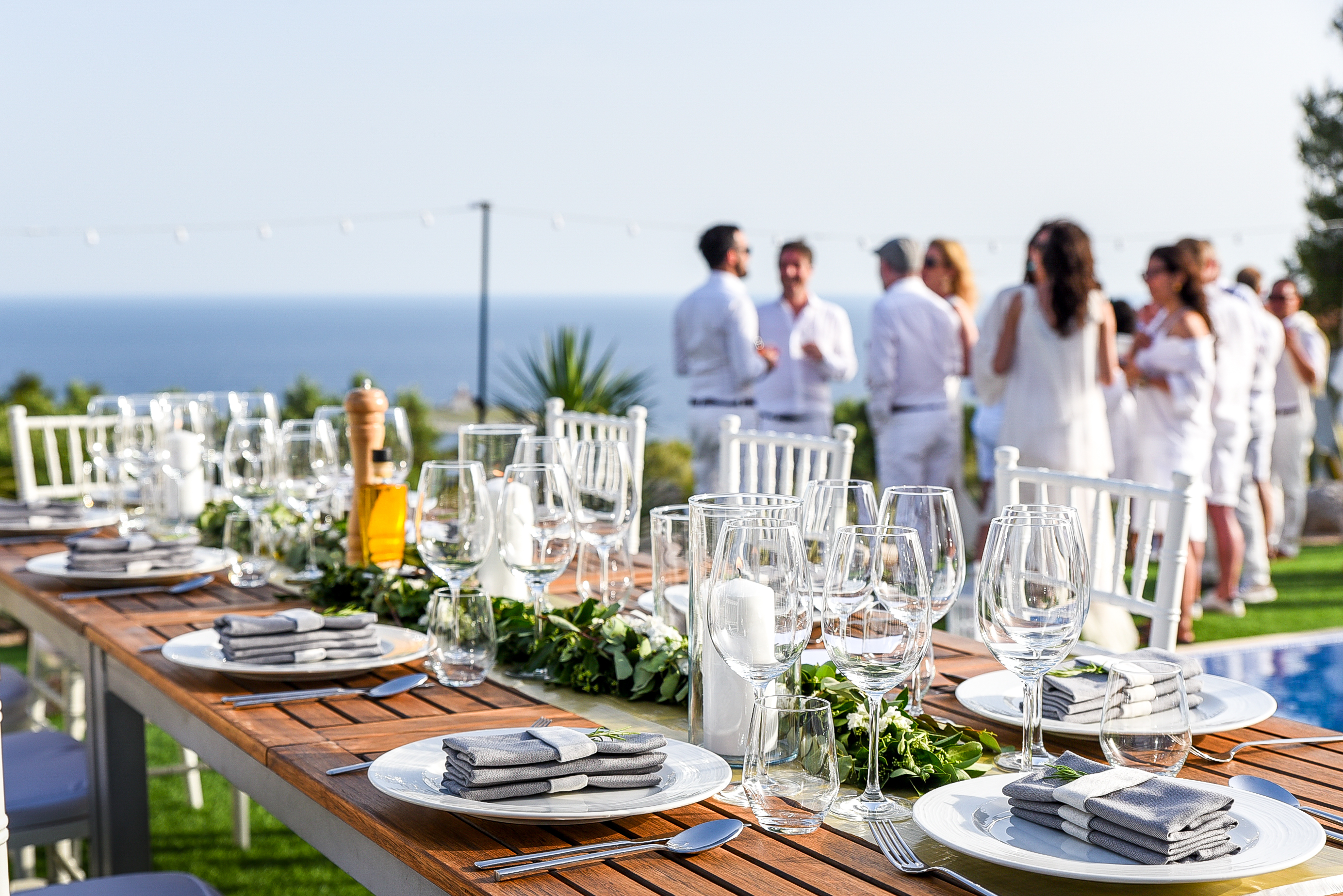 Outdoor dining table set for a private celebration with guests and sea view at villa near Dubrovnik