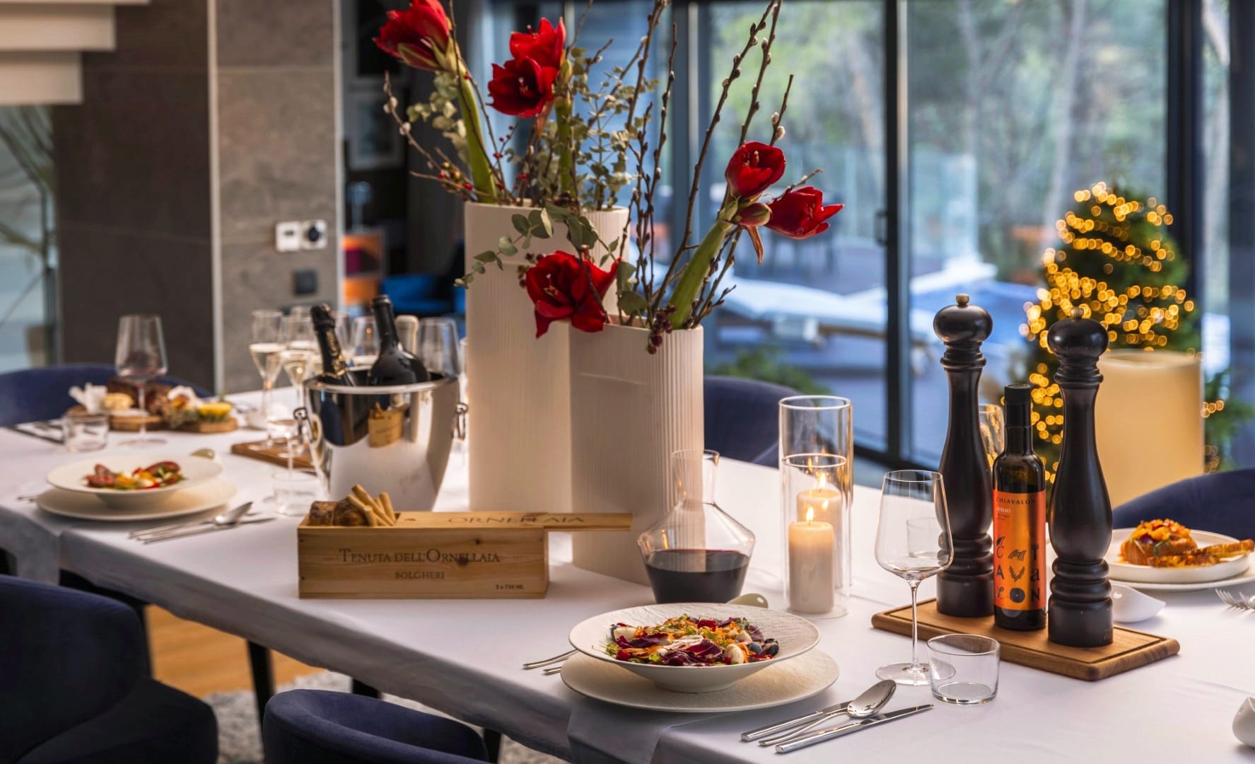 New Year's dinner table set with wine, candles and dishes prepared by a private chef at Villa Majesty, Mali Lošinj