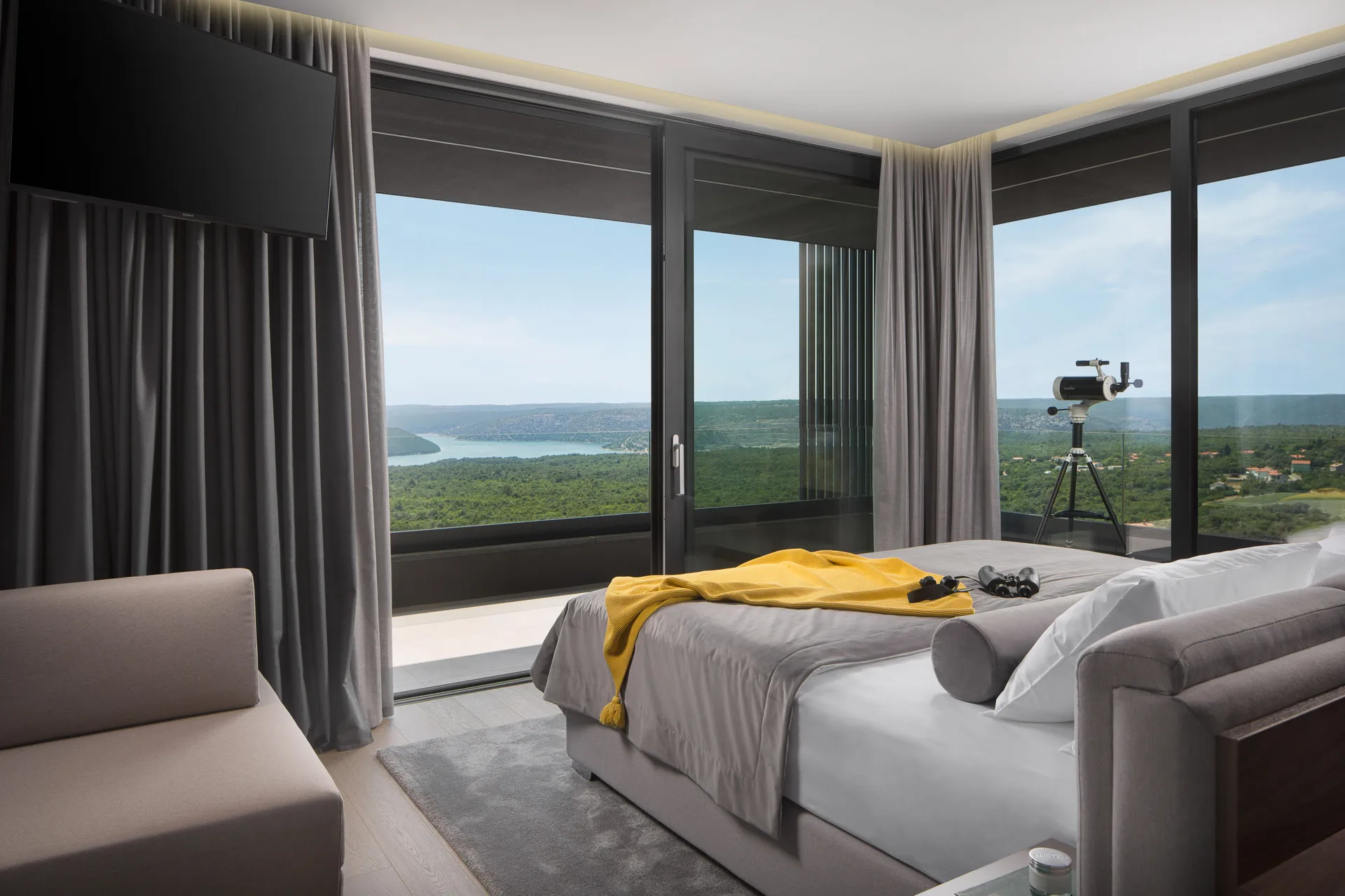 Bedroom with panoramic sea view over Raša Bay and a telescope on the terrace at Villa Panoramica Istra, near Koromačno