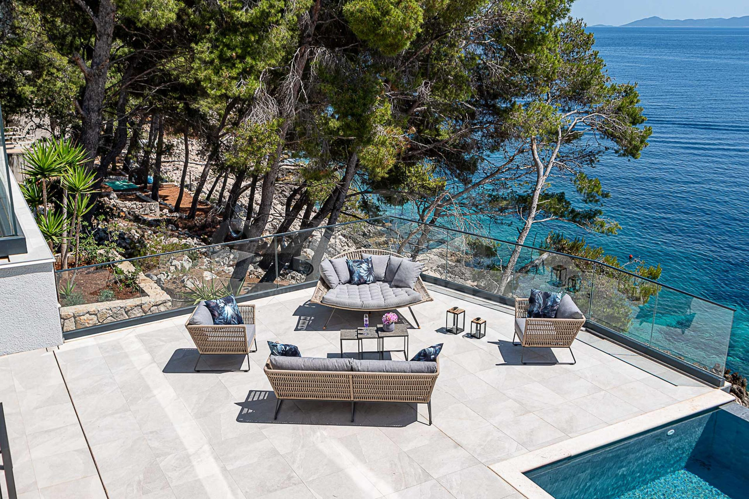 Seafront terrace with a lounge zone and a sea-view by the infinity pool in front of the luxury villa S Korcula with private parking in Prizba