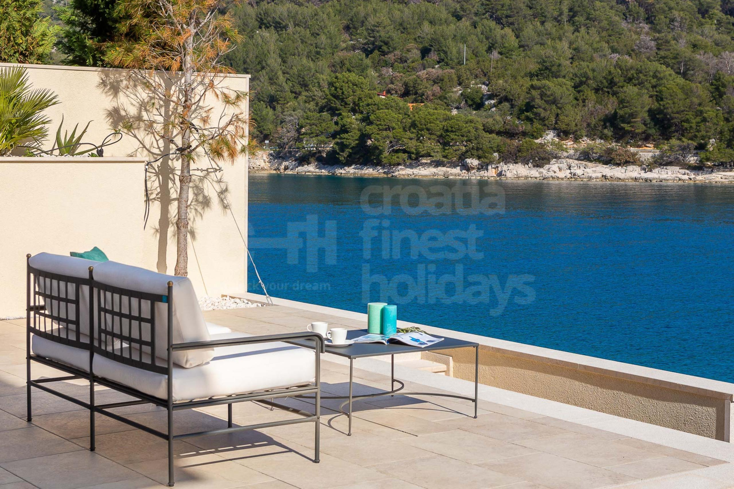 Seating area with outdoor furniture in Croatia luxury seafront villa for vacation with friends