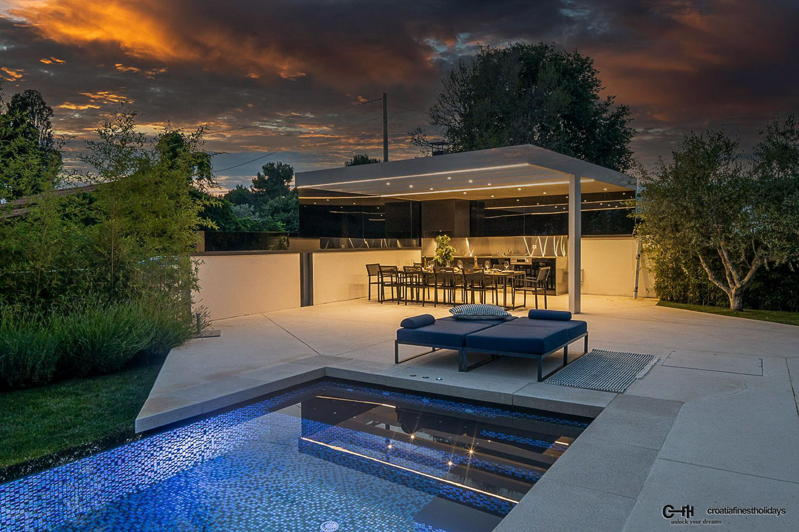 Outdoor dining table in the summer kitchen by the pool of a Croatia luxury villa Antal with total privacy in Istria