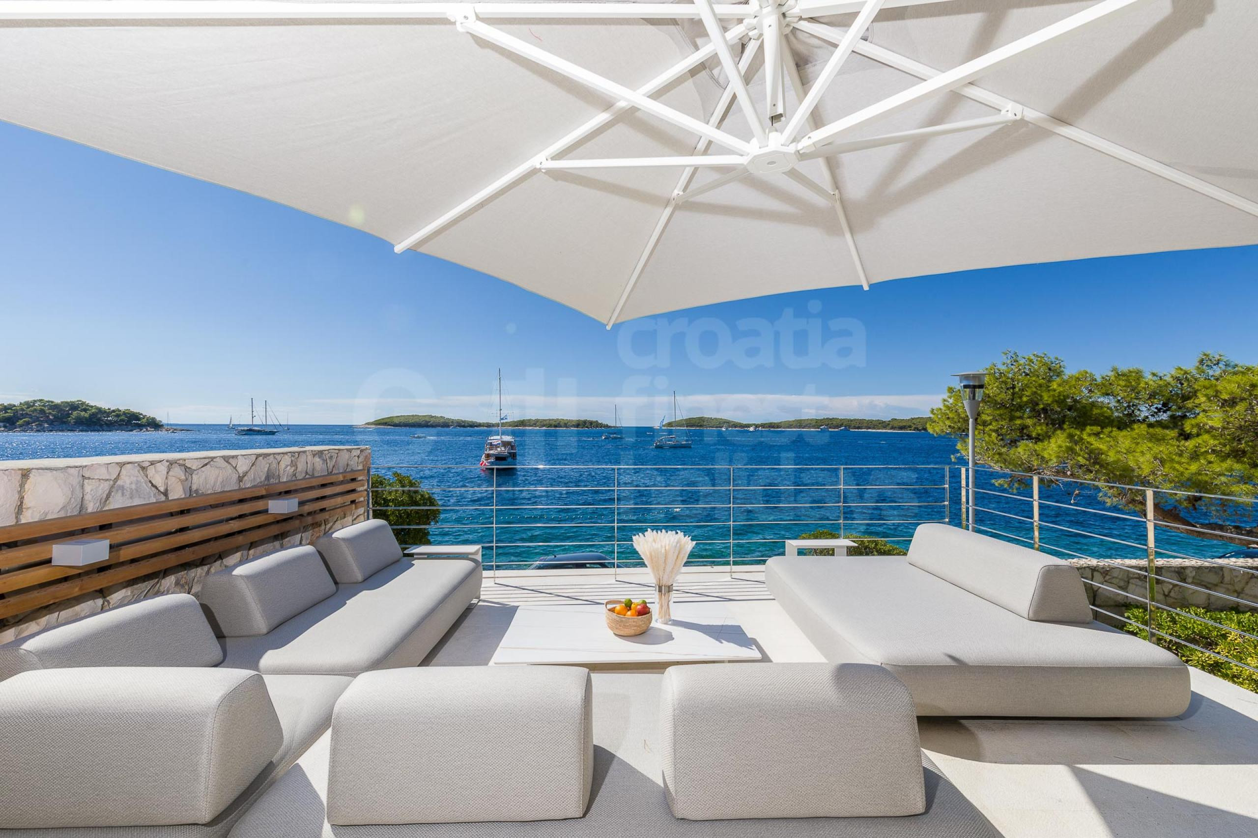 Outdoor fenced terrace with seating and sea view in the luxury villa Aqua Vista on the island of Hvar