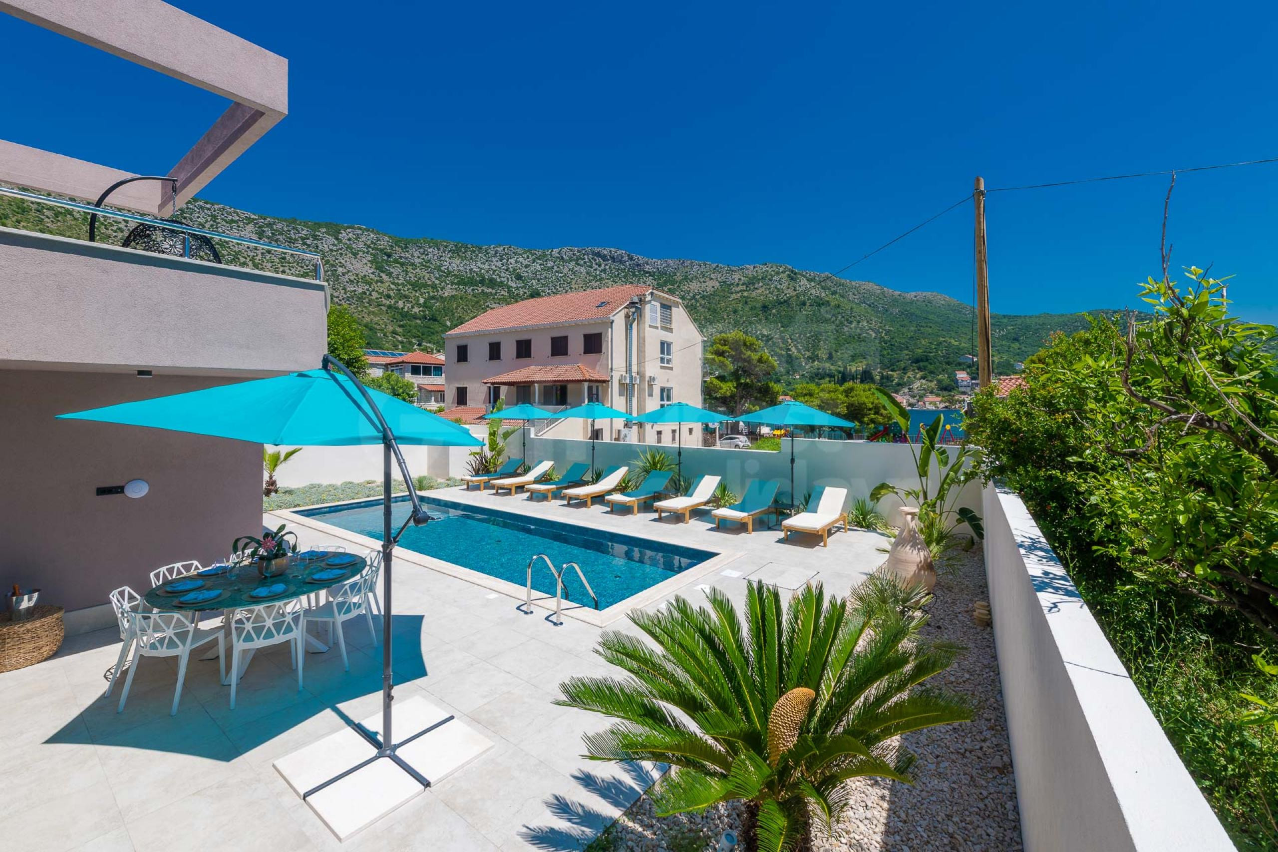 Swimming pool with sun loungers in villa Dubrovnik Lagoon by the sea