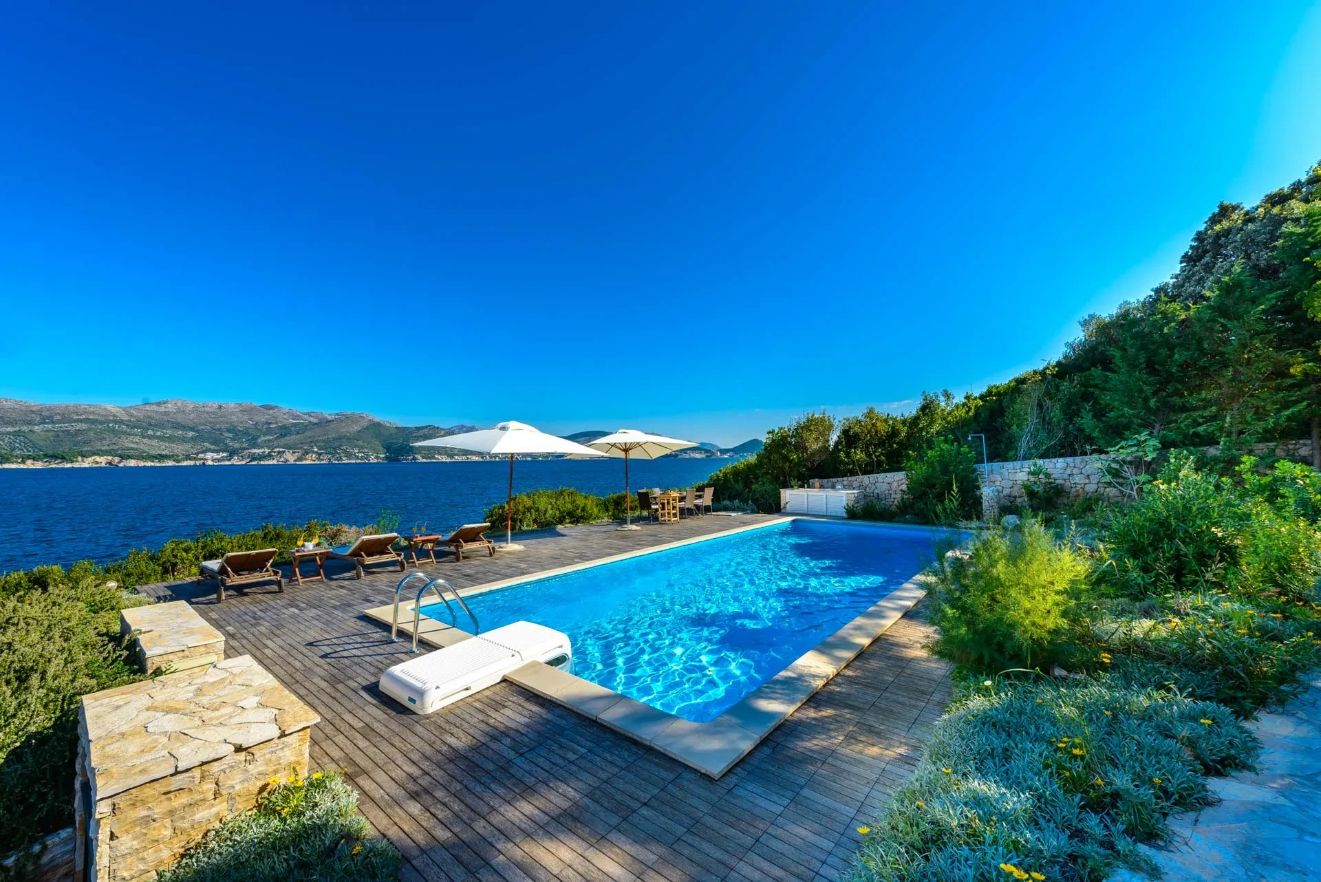 Private pool in front of the luxury Croatian beachfront villa Calamota with a gym and private sea deck right by the sea on Kolocep