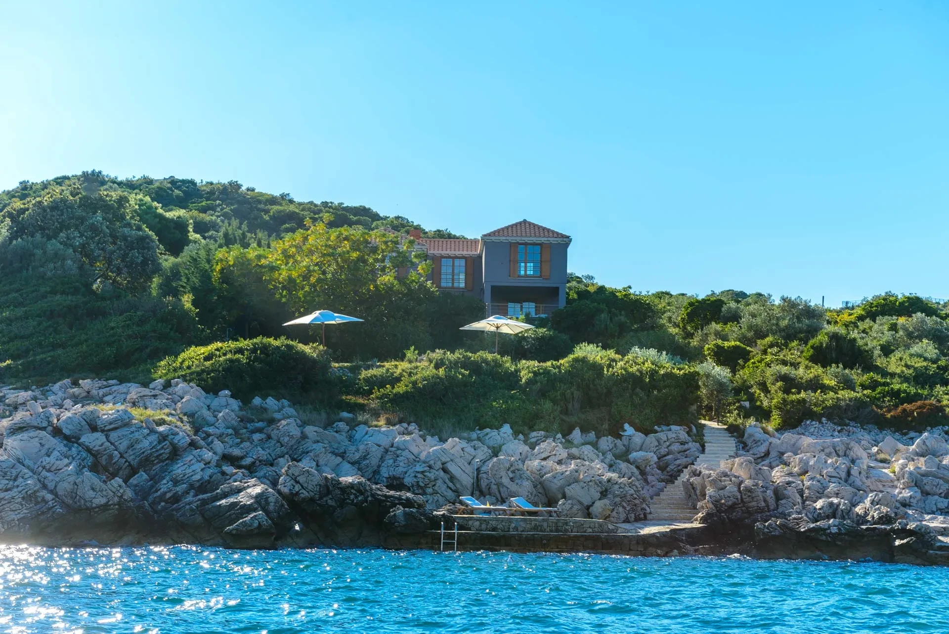 A view from the sea on the luxury beachfront holiday villa Calamota with private pool, parking, wifi