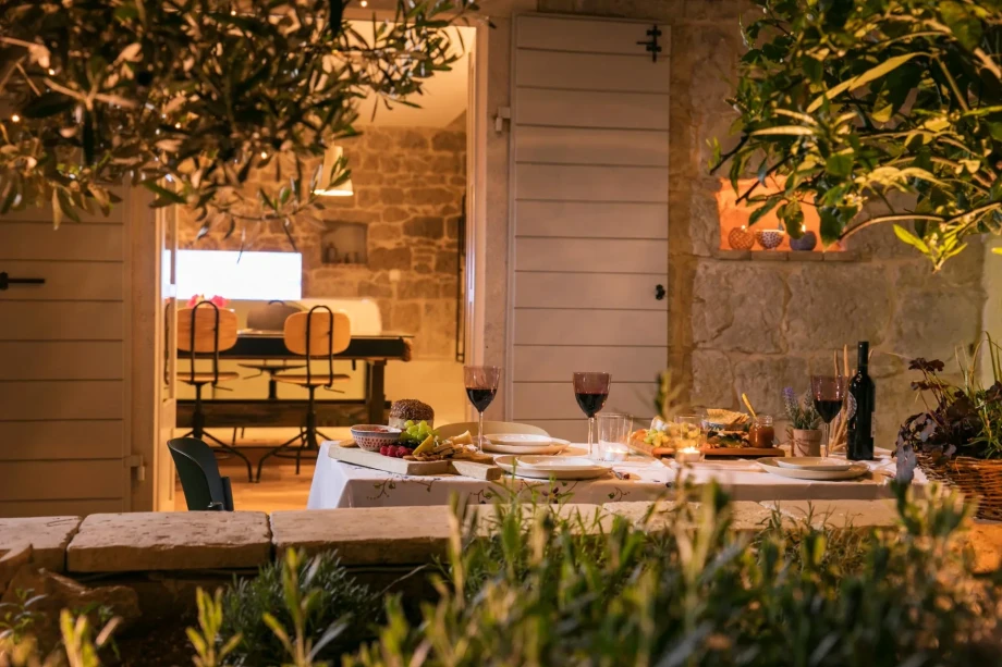 A charming outdoor dining setup at Villa Sweet Home in Split Old Town, complete with table settings and natural surroundings.