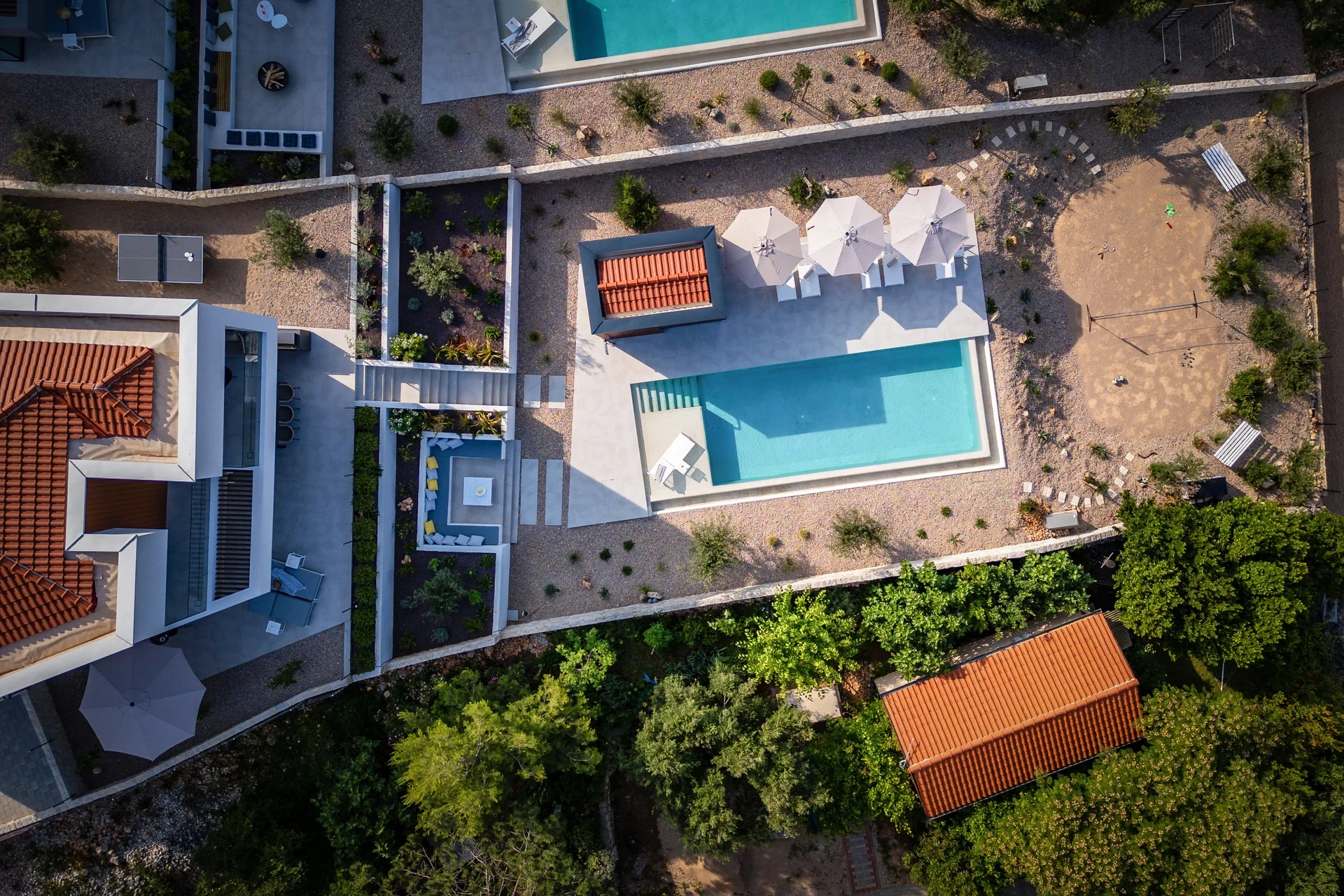 Overhead perspective of the villa with a swimming pool, highlighting the outdoor area and surrounding landscape.