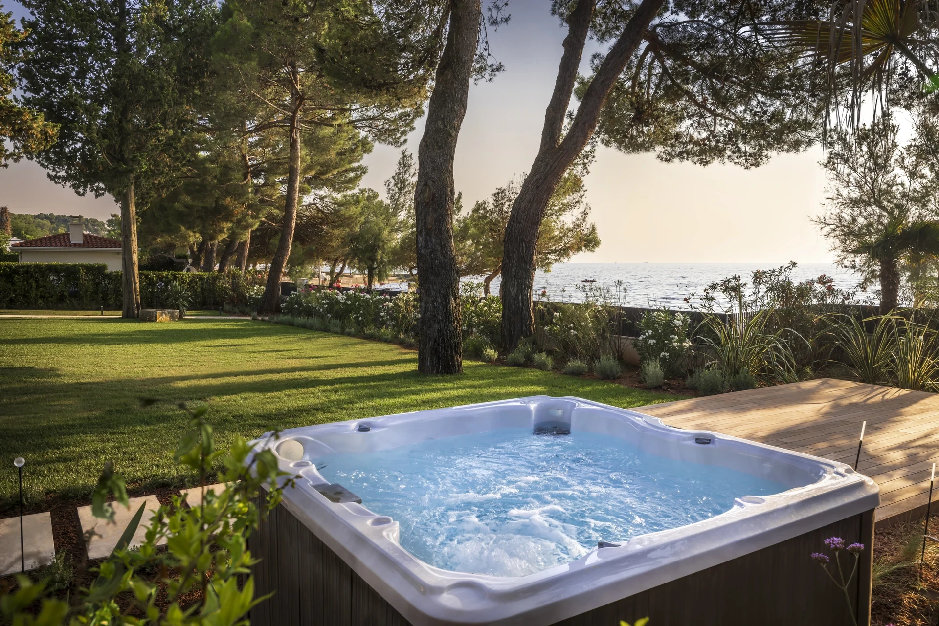 Enjoy a serene hot tub nestled in lush greenery at Villa Lani, Poreč, Istria, ideal for a luxurious Croatian holiday.