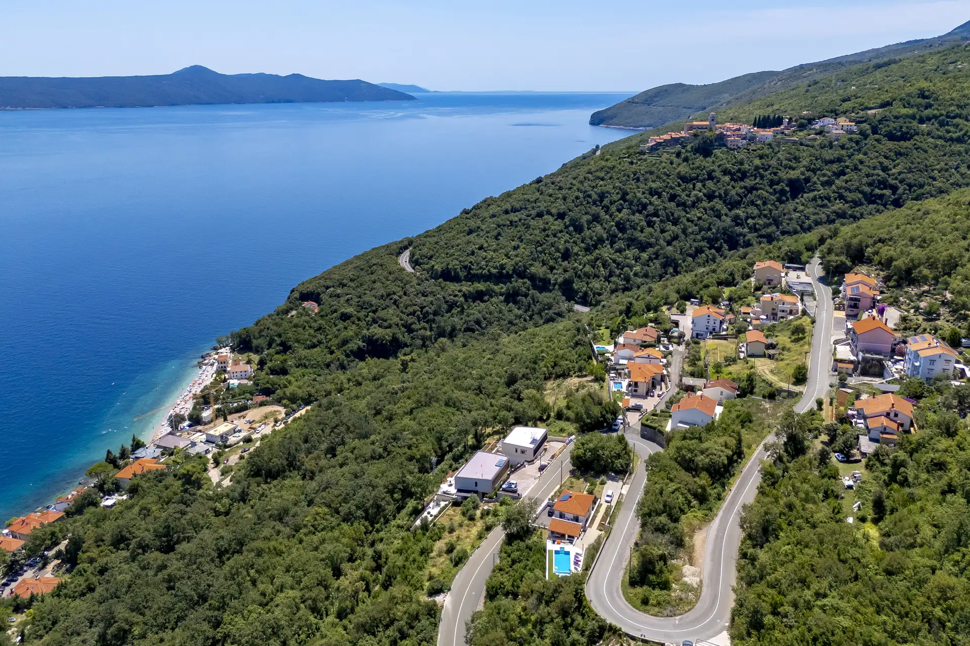 Aerial view of Villa Mistique, showing vicinity of beach and location in the nature near Opatija.