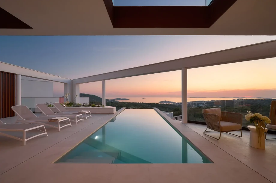 Scenic pool and lounge chairs with sea views at Villa Serena, Primosten, perfect for a family holiday in Croatia.