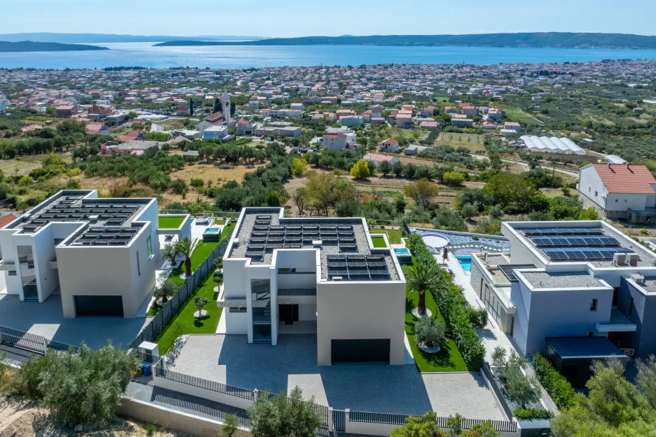 Modern villa featuring solar panels on roof, showing sustainable architecture and eco-friendly design.