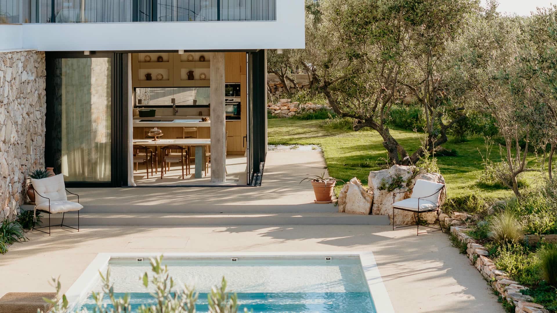 Aerial view of a modern two-story luxury villa Oliveto with pool on island Solta, integrated into a lush, green landscape