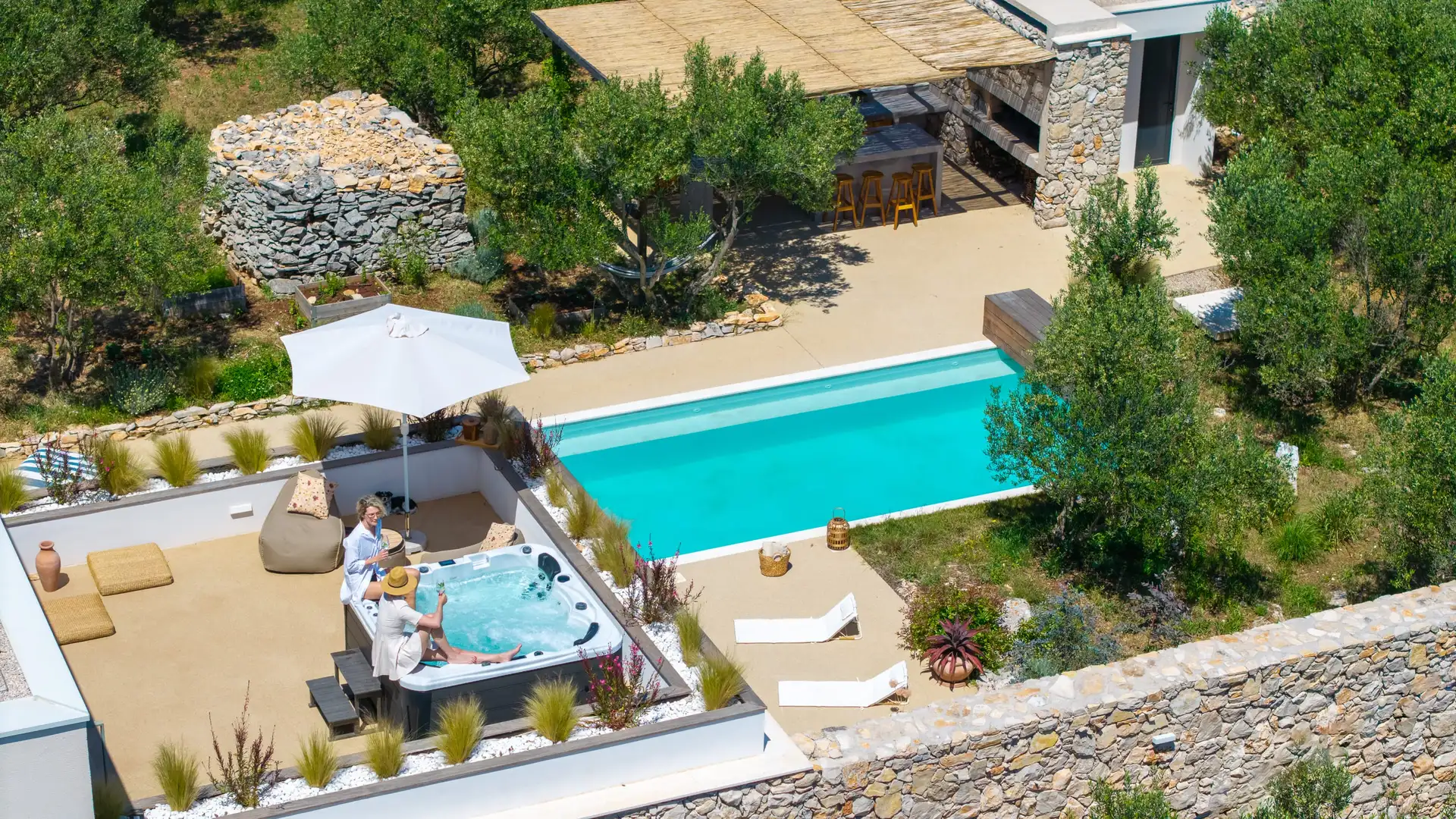 Stunning aerial shot of Villa Oliveto, featuring a serene pool and Jacuzzi in the island's natural beauty.