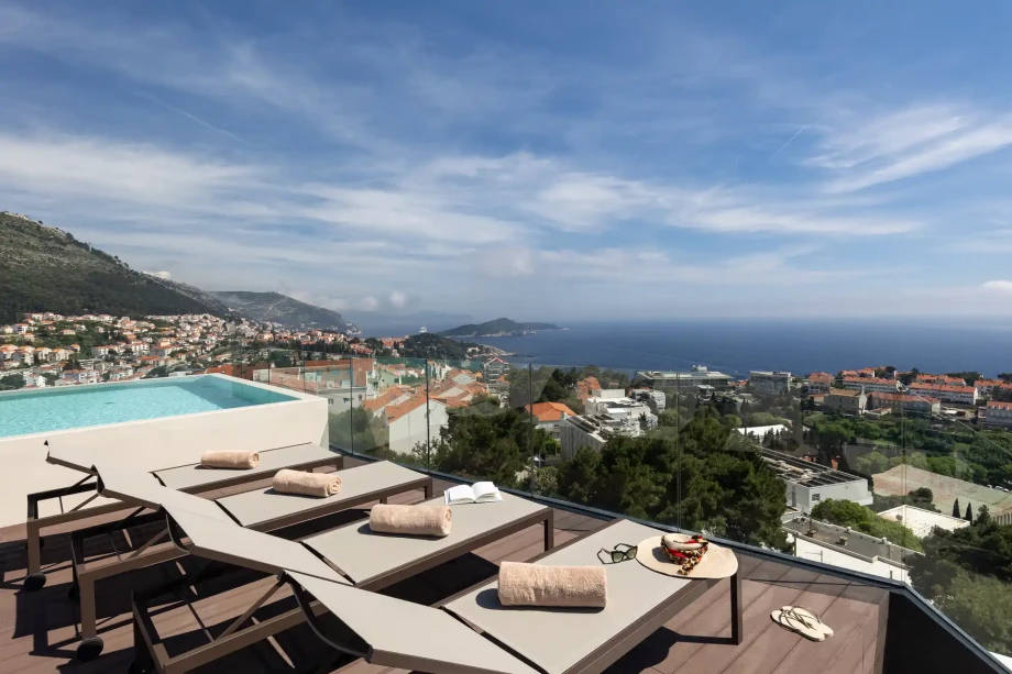 Rooftop sun terrace with loungers, swimming pool and panoramic views.
