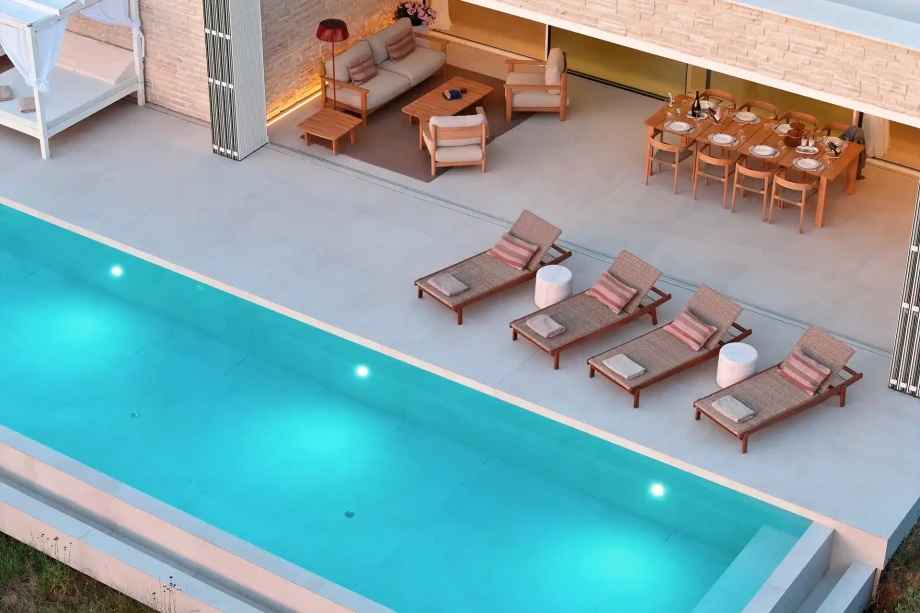 Swimming pool in Villa Sunset Novalja on island Pag surrounded by lounge chairs