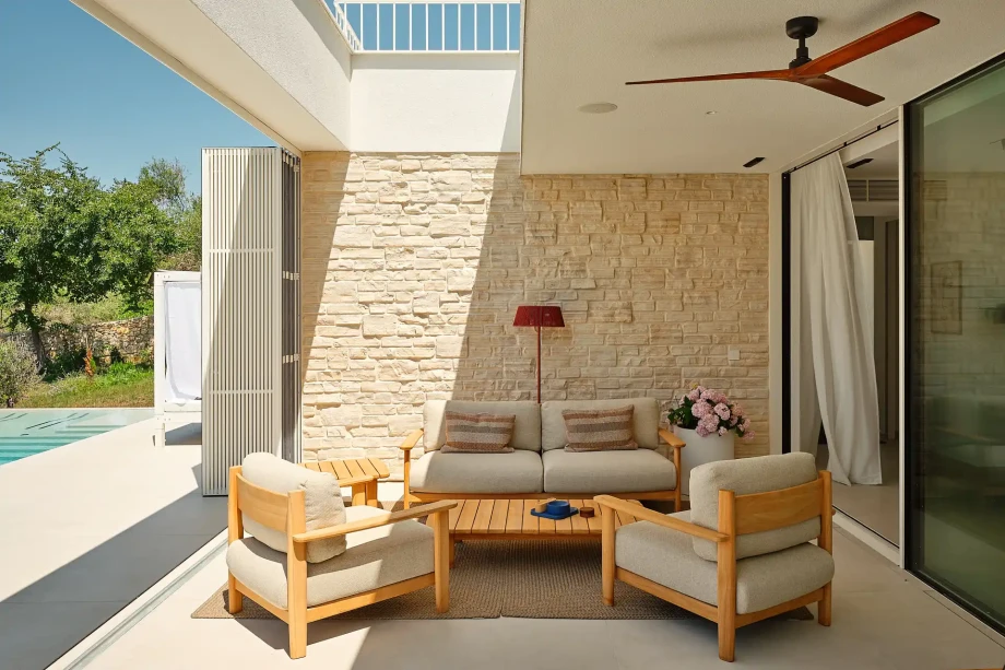 Outdoor patio with a lounge area and a pool presenting the ambiance of a family villa on Pag.