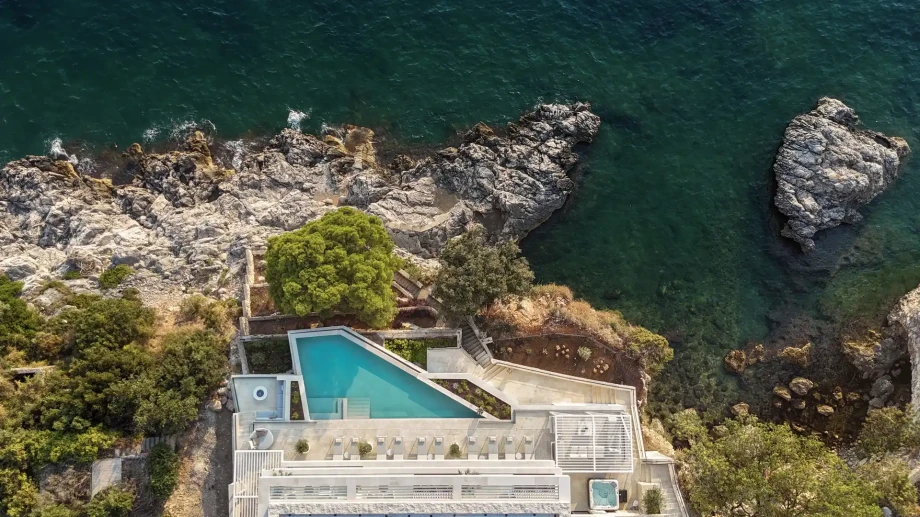 Aerial view of Villa Azurea Dubrovnik beside the rocky Adriatic coastline.