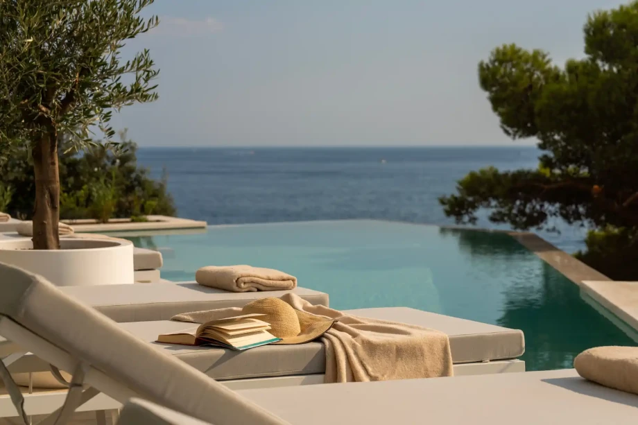 Sun loungers beside the infinity pool.