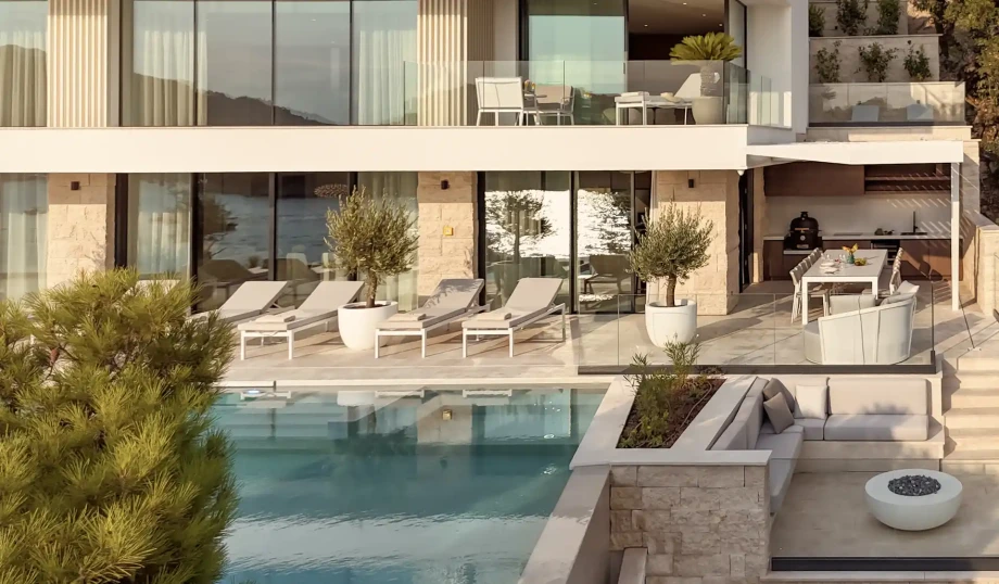 Pool terrace with sun loungers and outdoor dining area at Villa Azurea Dubrovnik.