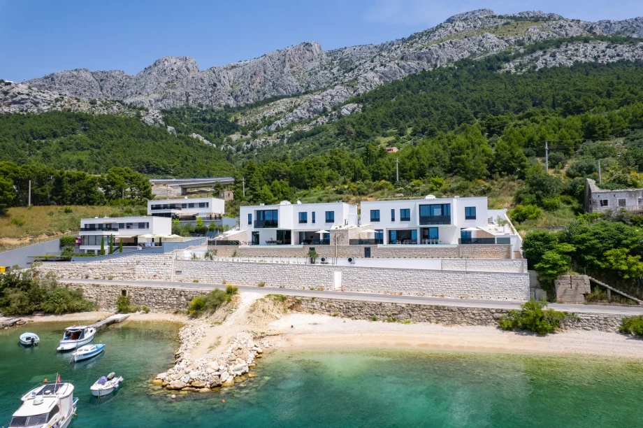 Aerial view of four neighbouring seafront villas with private pools near Omiš