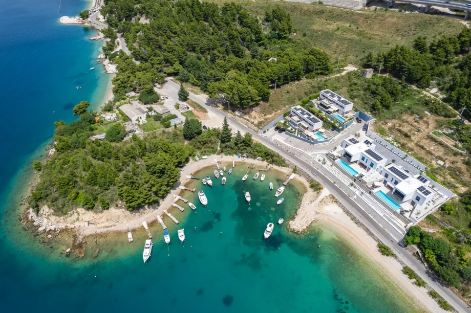 Aerial view of four neighbouring seafront villas with private pools near Omiš