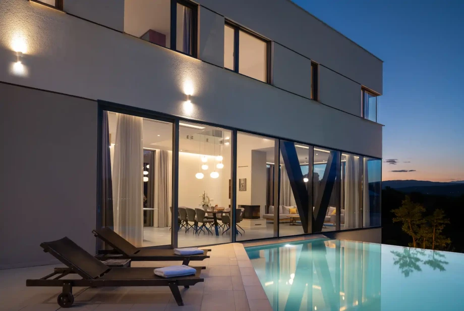 Villa Imota Ruby at dusk, with an infinity heated pool and open-plan living area near Imotski